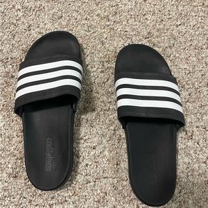 Women’s Adidas slides. Size: 10. Black with white stripes.